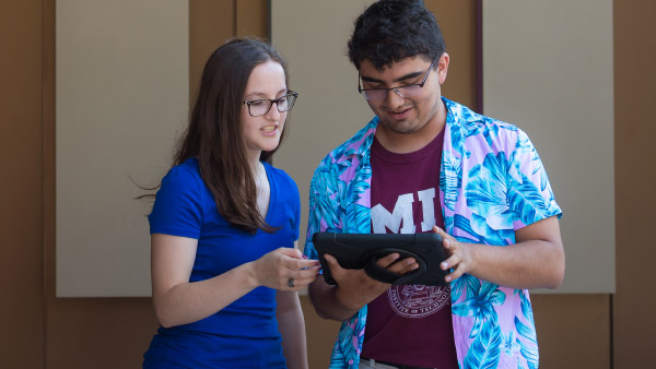 Photo: Advisor with a student using a tablet