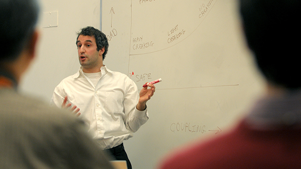 Faculty member teaching at a white board